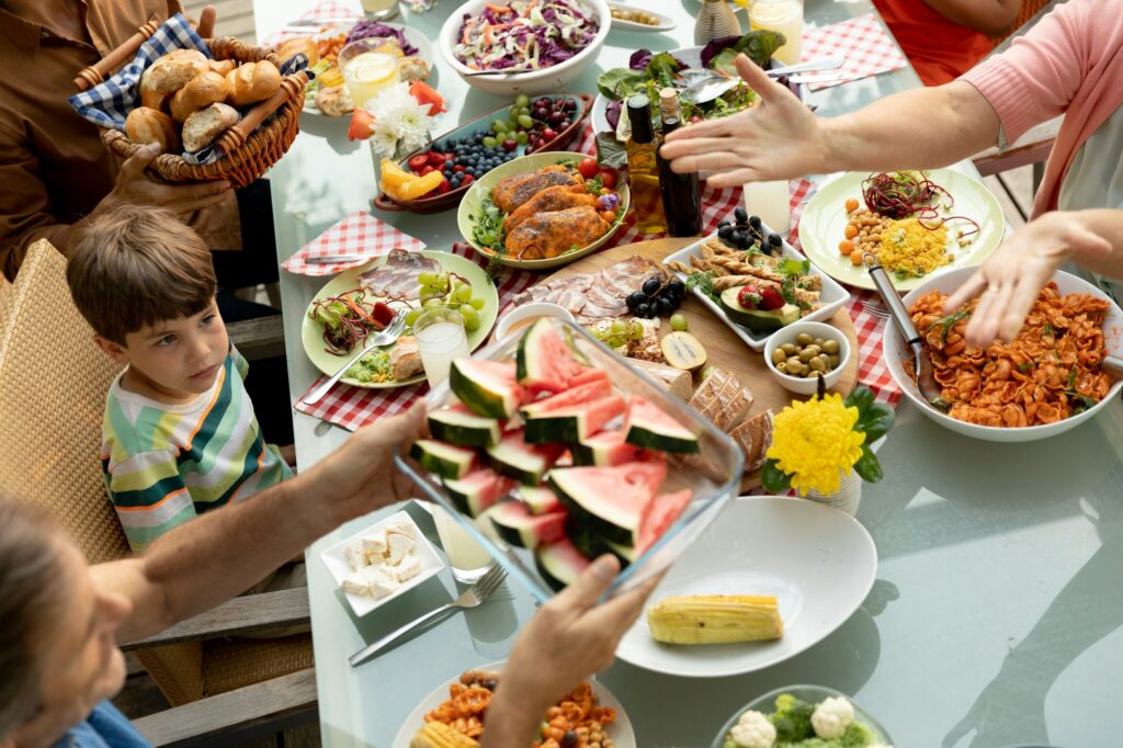 Family eating outside together in summer